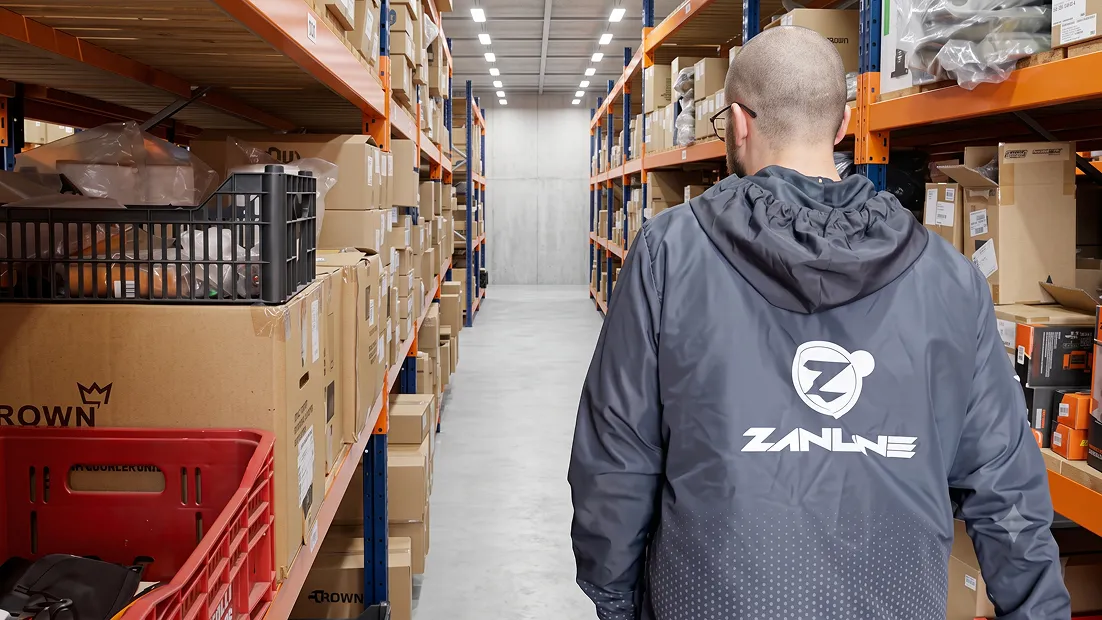 Colaborador da Zanline no corredor do estoque, entre prateleiras de produtos